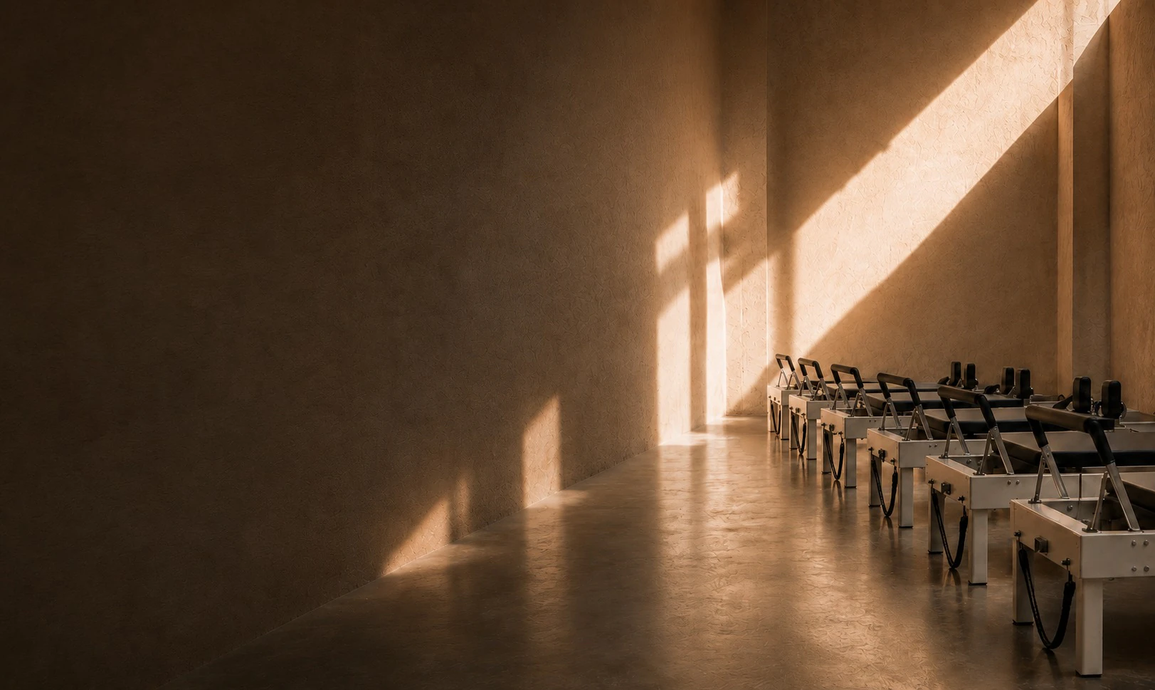 Warm Pilates studio with reformers in afternoon light